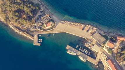 Drop down view of coastal village at sunset.
