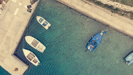 Drop down view of fishing port with boats tied in.