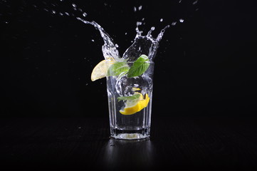 lemon splash in glass of water isolated on white background