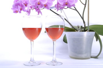 two glasses of red wine and flowers