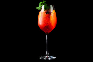 red cocktail with cherry on black background