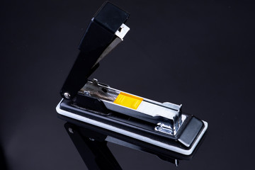 Office tacker opened with tacker staples with yellow plastic