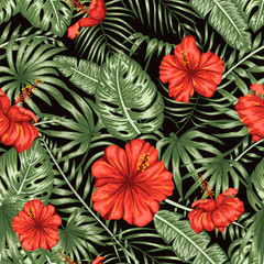 Vector seamless pattern of green tropical leaves with red hibiscus flowers on black background. Summer or spring repeat tropical backdrop. Exotic jungle ornament