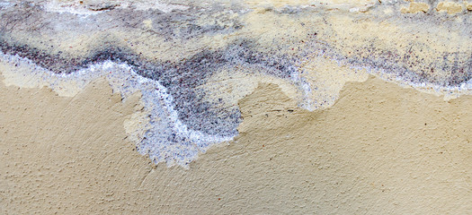 Fototapeta na wymiar Old weathered painted wall background texture. White dirty peeled plaster wall with falling off flakes of paint.
