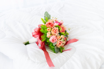 Beautiful pink flower bouquet on white fabric background