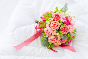 Beautiful pink flower bouquet on white fabric background with copy space