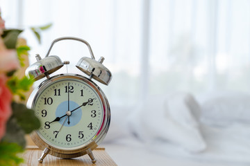Alarm clock on the table in the bedroom with copyspace