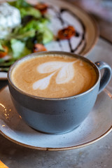 Hot Latte Heart, gray cup, blur background, coffee in cup
