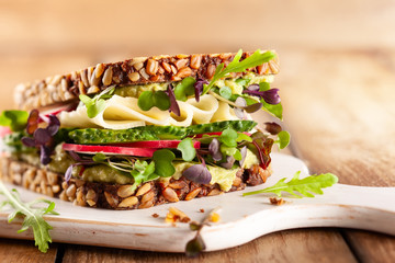 Fresh vegetarian  sandwich  with cheese and veggies.