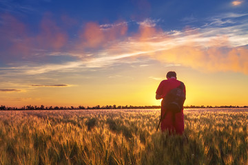 Fototapeta na wymiar people wheat field sunset / landscape spring field agriculture of Ukraine