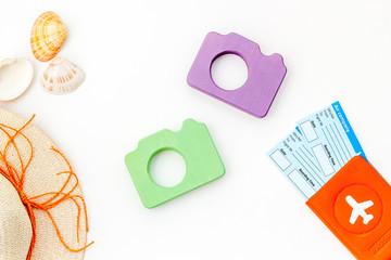 photo camera, hat and passport with tickets for travel on white background top view