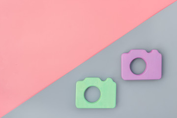 photo camera concept on pink and gray background top view copy space