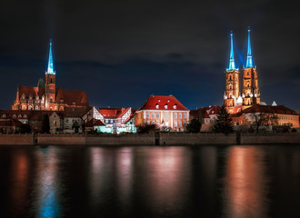 Fototapeta premium The view on the night a cityscape cathedral, river Odra. Wroclaw, Poland, dusk