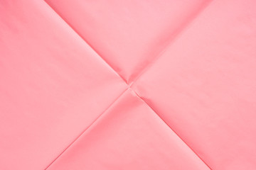 Pink coral wrapping paper background with crease texture. Geometry abstract art concept backdrop.