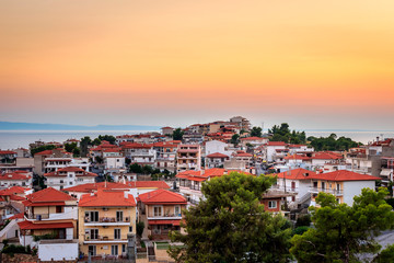 Golden hour view of amazing Neos Marmaras cityscape in Greece from a nearby vantage point