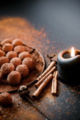 Dark chocolate truffles on black background 