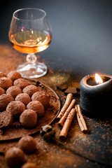 Dark chocolate truffles on black background 