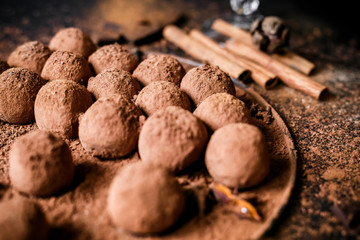Dark chocolate truffles on black background 