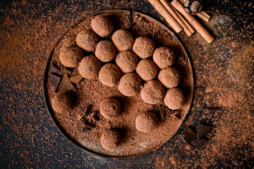 Dark chocolate truffles on black background 