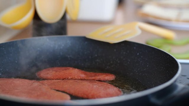 Three smoking hot rations of Quorn veggie & vegan bacon, sizzling in a hot frying pan full of sizzling oil, a great breakfast supplement for national vegetarian week.