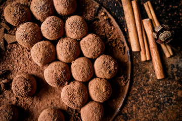 Dark chocolate truffles on black background 