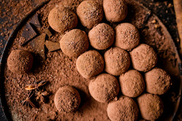 Dark chocolate truffles on black background 