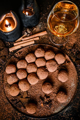 Dark chocolate truffles on black background 