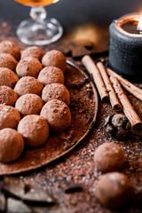 Dark chocolate truffles on black background 