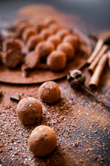 Dark chocolate truffles on black background 