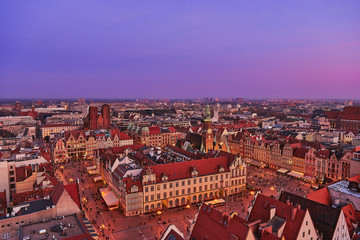Fototapeta na wymiar Aerial view of the sunset of Stare Miasto with Market Square, Old Town Hall and St. Elizabeth's Church from St. Mary Magdalene Church in Wroclaw, Poland