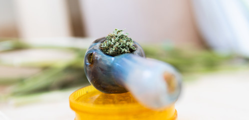 glass smoking pipe with marijuana close-up. Smoking culture consept