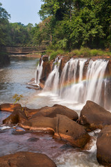 Colourful rainbow over Tad Pha Suam waterfall.