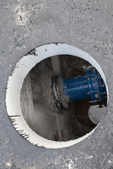 Open manhole in the concrete block