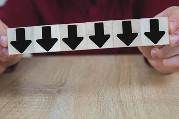 a person pulls one of the wooden cubes standing on the table, all of them are black, except they...
