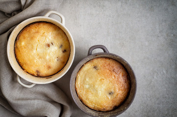 Two pans with cottage cheese casserole on gray table