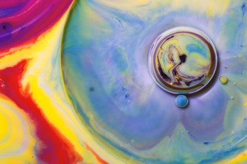 Macro photography of colorful bubbles in some fluids producing vibrant fleeting microworlds that are eternalized in a picture.