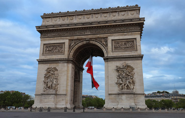 The Triumphal Arch decorated with French flag, Paris, France