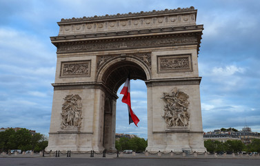 Fototapeta na wymiar The Triumphal Arch decorated with French flag, Paris, France