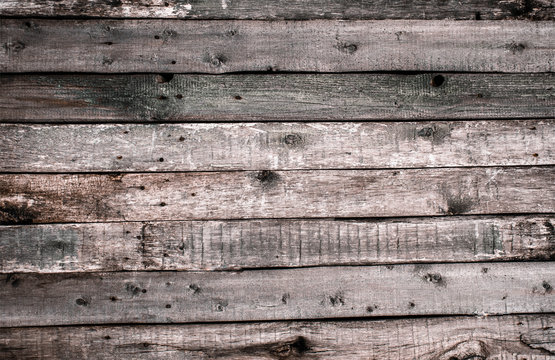 The texture of the old wooden fence with chopped off knots and cracks. Wallpaper for vintage design