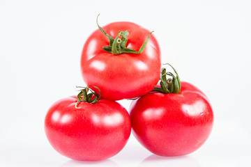 Some Fresh tomatoes on a white background