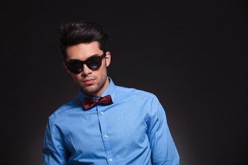 Obraz premium Serious looking young male standing and staring forward