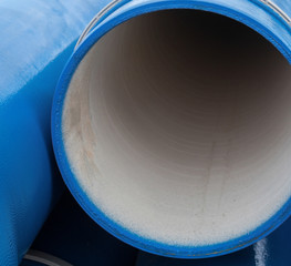 Stack of new blue pipes (tubes)