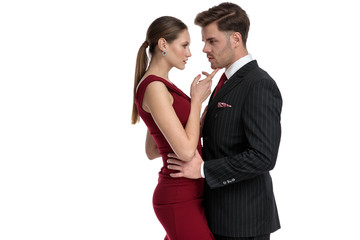 Charming man holding his girlfriend by the hips