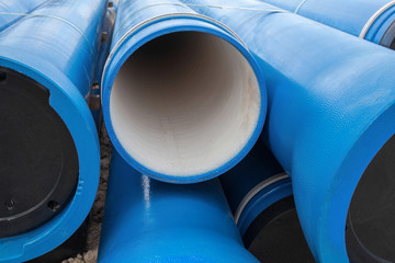 Stack of new blue pipes (tubes)