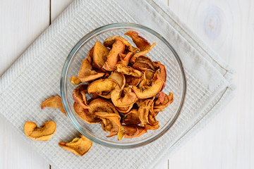 Dried apples in a glass bowl, top view