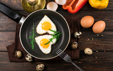 Fried eggs in the form of a heart in a skillet