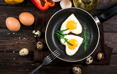 Fried eggs in the form of a heart in a skillet
