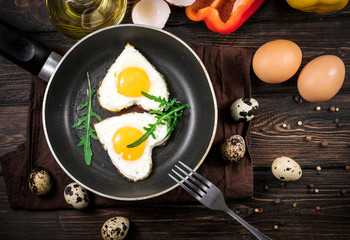 Fried eggs in the form of a heart in a skillet