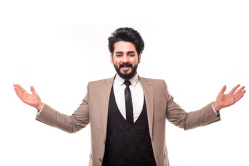 Young arab man with arms raised. Guy spread hands out. Isolated on white background. Bearded student wearing a white shirt arms opened looking up.