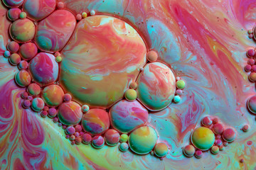 Macro photography of colorful bubbles in some fluids producing vibrant fleeting microworlds that are eternalized in a picture.